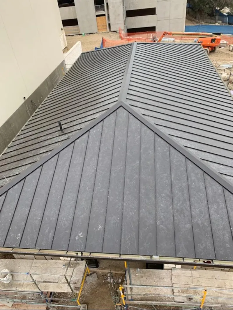 Commercial metal roof construction with crane equipment in West Odessa