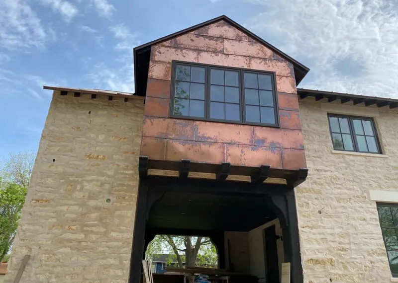 Copper metal panel facade on a stone building for Metal Roof Coating in West Odessa